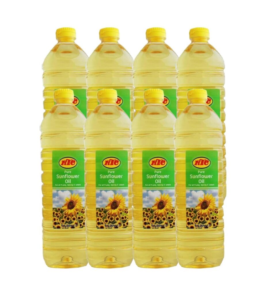 KTC Pure Sunflower Oil 1L bottle with golden oil being poured into a frying pan with fresh vegetables, high smoke point cooking oil, rich in vitamin E and polyunsaturated fats.