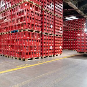 Coca‑Cola Zero Sugar in a red-labeled 12 oz can and a 591 ml bottle, alongside ice cubes, fresh lime wedges, and the iconic Coca‑Cola red and black branding.